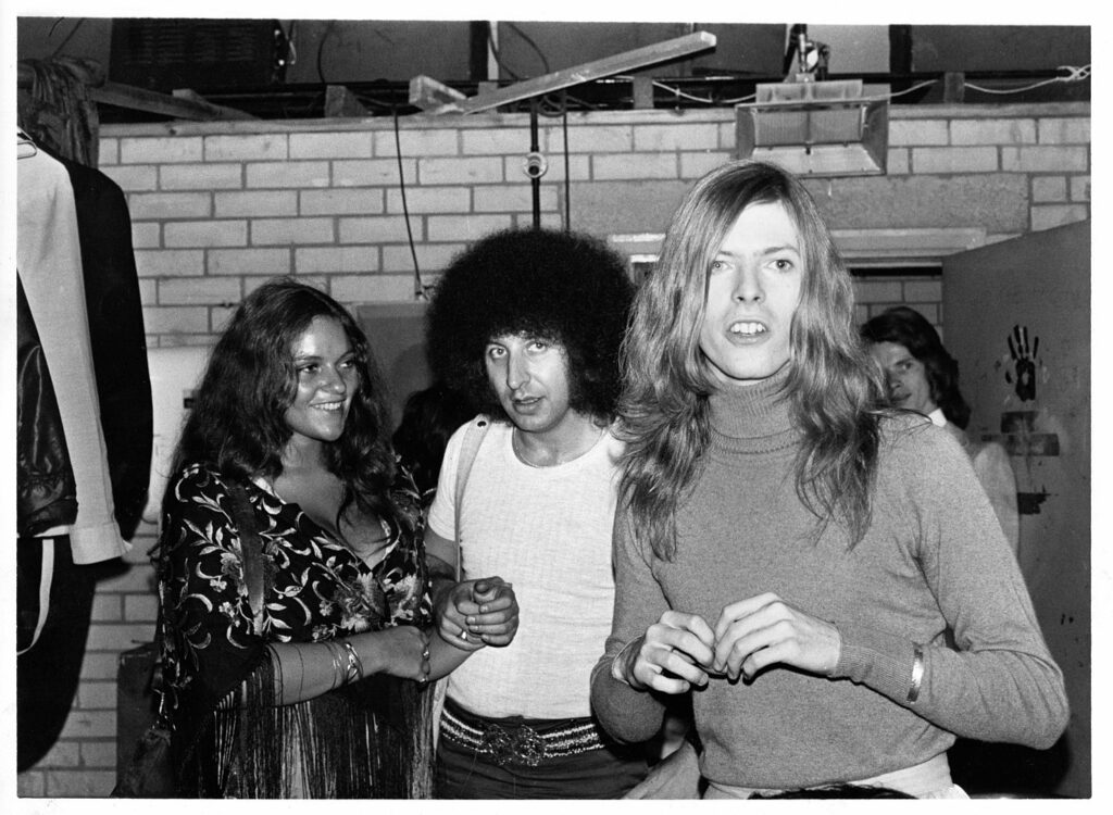 Dana Gillespie, Tony Defries and David Bowie at Andy Warhol's Pork at London's Roundhouse in 1971 (Photo credit: Mainman Archive)